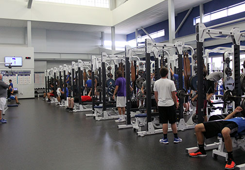 Students in Kris Henry fifth block white bench press. Weights classes were coed until this year when they switched to gender based sections.