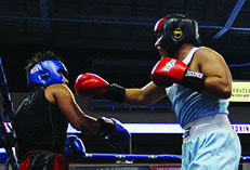  Angel Santander punches his opponent during a match. He later went on to win the match. 