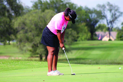 On hole 8, senior Alexis Bailey prepares to put the ball. 
Bailey and her scramble partner Taylor Snell shot a 44. 