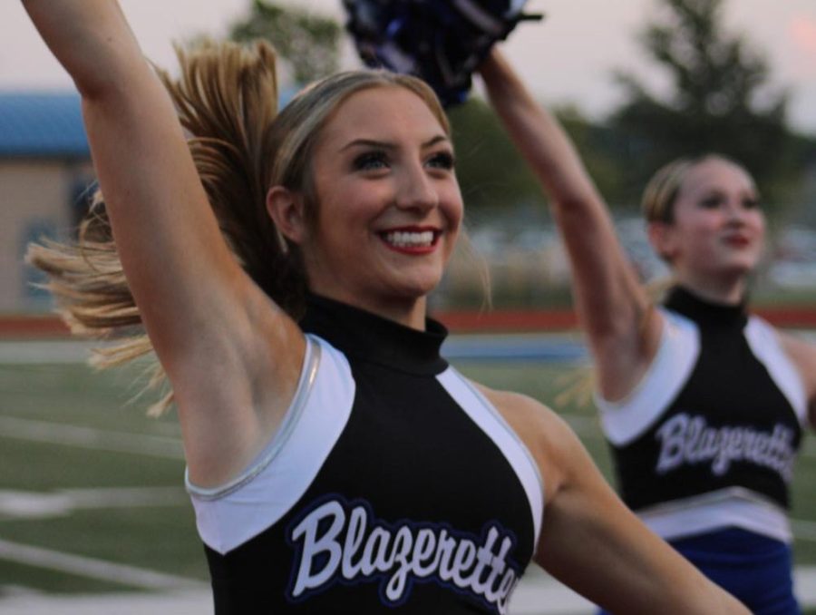Senior Ellie Bockus cheering with her Blazerette teammates at a football game this past fall.
