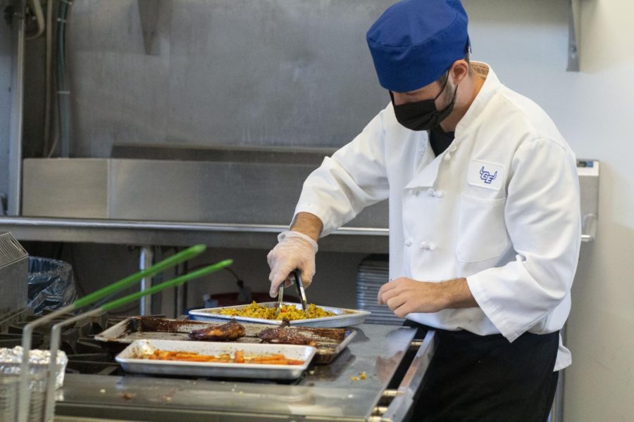 Senior Luka Majstorovic cooking in a kitchen.