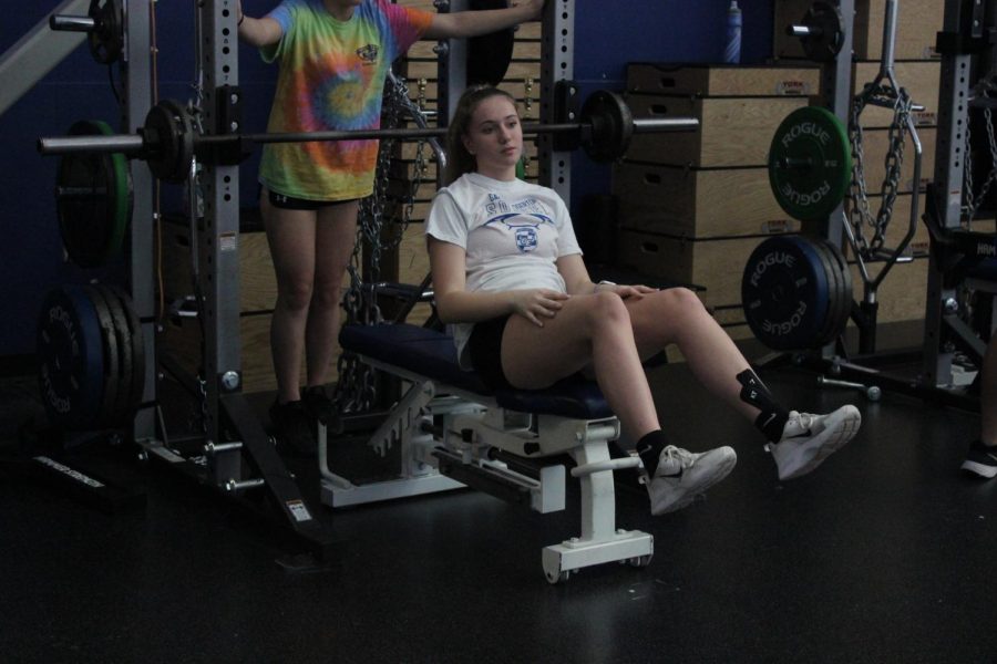 Two girls in the weights classroom.