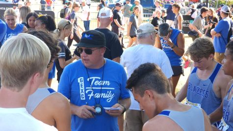 Walt Cochran coaching the varsity cross country team at the JK Gold Classic in Wichita Kansas.