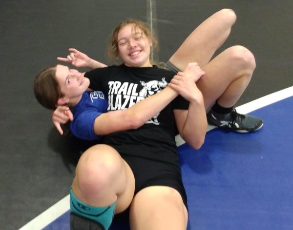 Alexia Marks and Breann Roberts wrestling.